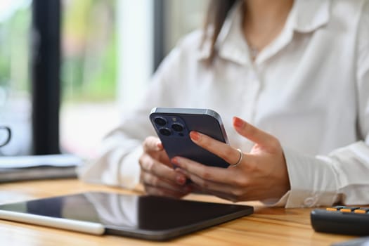 Select focus on woman hands using smartphone texting messages, chatting in social during break.