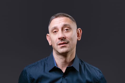 portrait of a man in a dark blue shirt