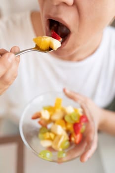 woman eating fruit during snack.