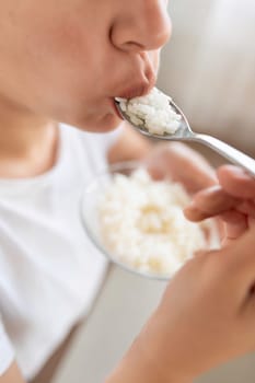 young woman eating rice while dieting.