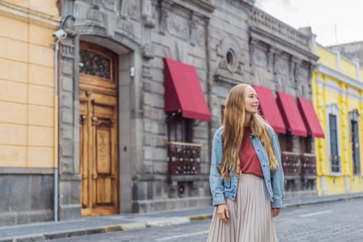 Female tourist walking through the colorful colonial streets of Puebla, Mexico. Travel, cultural exploration, and vibrant architecture concept.