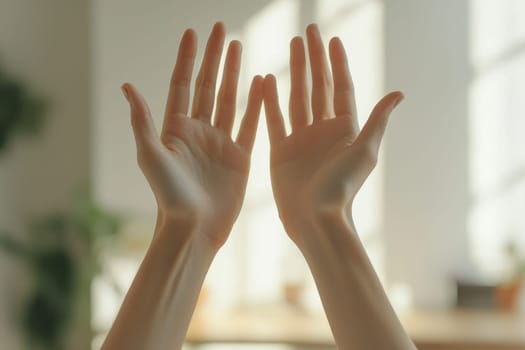 Two hands are raised in the air, one of which is touching the other. Concept of peace and unity, as if the two hands are reaching out to one another in a gesture of friendship or love