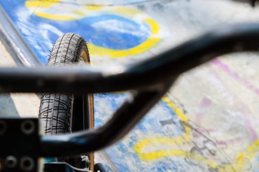 Close up of bmx bike on a ramp in a skatepark, BMX concept.