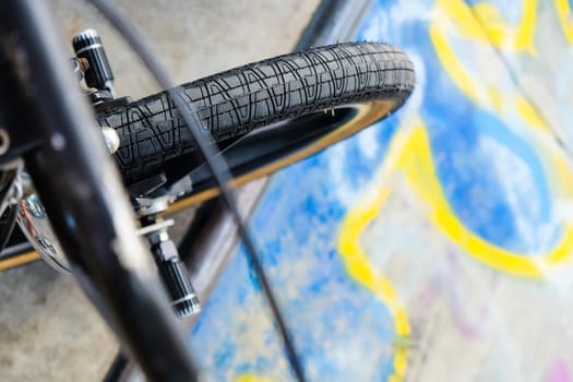 Close up of bmx bike on a ramp in a skatepark, BMX concept.