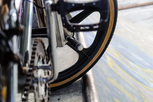 Close up of bmx bike on a ramp in a skatepark, BMX concept.