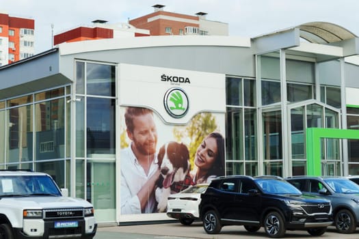 Tyumen, Russia-August 10, 2024: Skoda service center sign against a cloudy sky in a busy automotive district