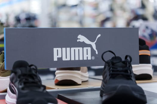 Tyumen, Russia-August 11, 2024: Trendy athletic shoe Puma is prominently showcased in a retail setting, highlighting its unique color combination and design