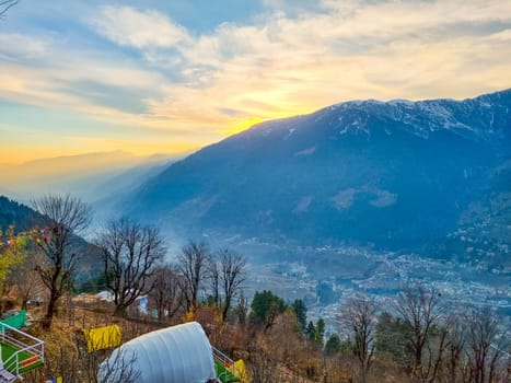 geodesic and swiss tents overlooking manali valley at sunset at a popular glamping spot near hampta village for eco freindly and comfortable adventure stays