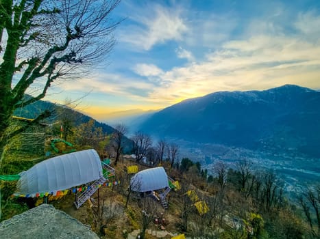 geodesic and swiss tents overlooking manali valley at sunset at a popular glamping spot near hampta village for eco freindly and comfortable adventure stays