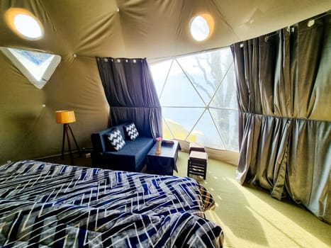 Interior of geodesic, triangular and swiss tents at a popular glamping spot near hampta village manali for eco freindly and comfortable adventure stays in India