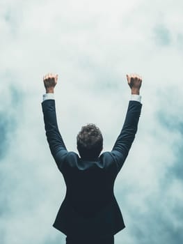 A man in a suit is standing in the air with his arms raised, looking up at the sky. Concept of triumph and accomplishment, as if the man has just achieved something great