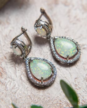 Elegant earrings with sparkling opals and diamonds, showcasing the beauty of jewelry craftsmanship