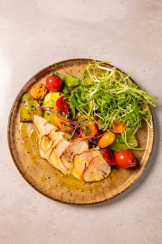 Grilled chicken breast seasoned with spices and served on a plate with grilled vegetables and lettuce
