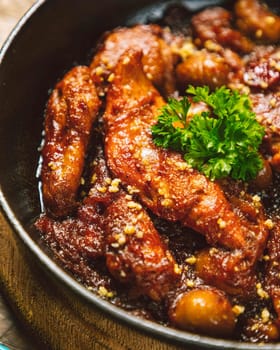 Chicken breast fillets are cooking in a delicious spicy sauce with herbs