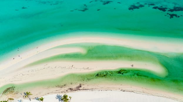 Aerial view of beautiful beach, palm trees by turquoise water. Bantayan island, Philippines.