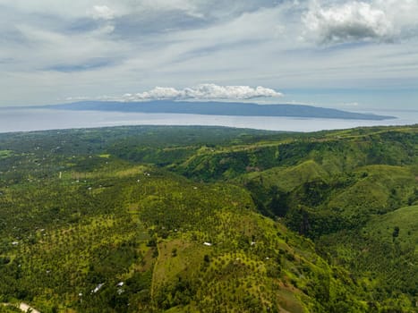 Aerial view of coastline of Negros Island with towns and farmland. Philippines.