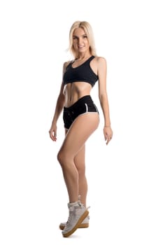 Slim fitness trainer in sportswear isolated full-length shot