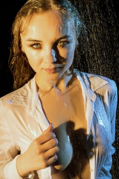 Pretty girl topless having shower in the dark room portrait