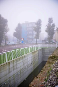 Cremona, Lombardy, Italy - November 7th 2024 Remains of roman walls emerging from a canal in the city center on a foggy day