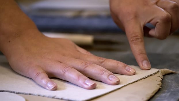 Hands skillfully shaping soft clay, showcasing unique artistry and fine craftsmanship in the art of pottery making. Stock Clip