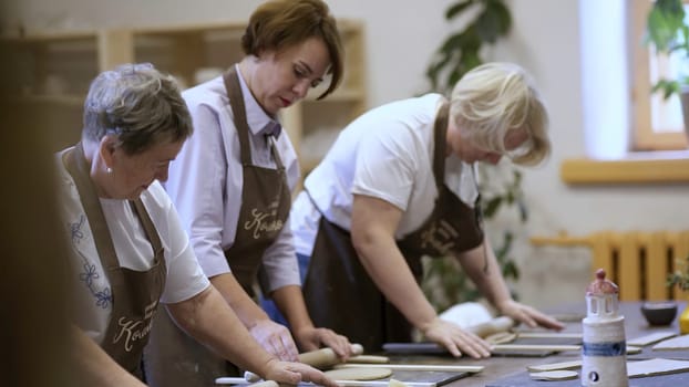 A cheerful group of women is having an enjoyable time baking together in a bright and welcoming kitchen space. Stock Clip