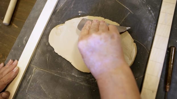 A person skillfully working with clay, demonstrating the intricate and delicate process of sculpting art. Stock Clip