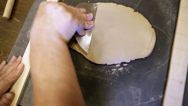 A person skillfully working with clay, demonstrating the intricate and delicate process of sculpting art. Stock Clip