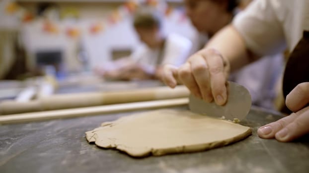 In an art studio, a skilled artisan meticulously shapes and molds clay, showcasing both creativity and craftsmanship. Stock Clip