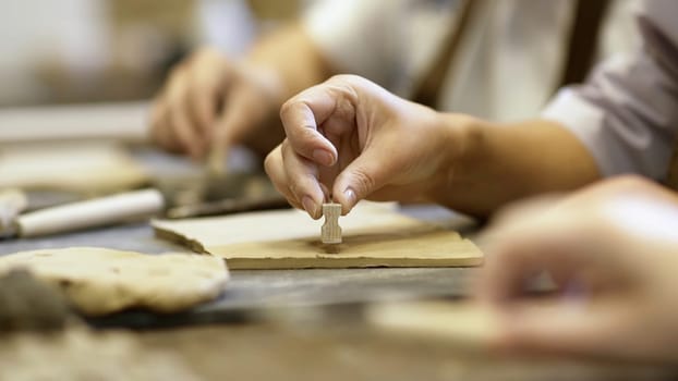 A closeup view showcasing highly skilled hands meticulously shaping clay within an artistic workspace environment. Stock Clip