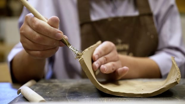 A skilled and dedicated artisan meticulously shapes clay pottery, showcasing great attention to detail and creativity. Stock Clip