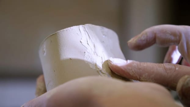 An artisan skillfully shapes soft clay, showcasing the intricate and beautiful art of sculpting with expertise. Stock Clip