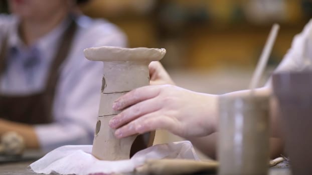 Explore the captivating world of pottery with vibrant clay creations in an engaging workshop experience. Stock Clip