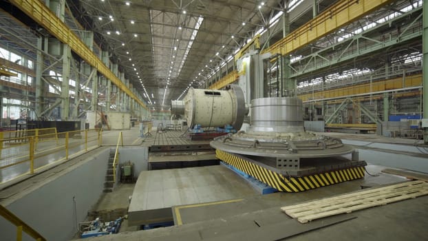 A large, expansive industrial space that is showcasing an array of heavy machinery and various manufacturing equipment. Stock Clip