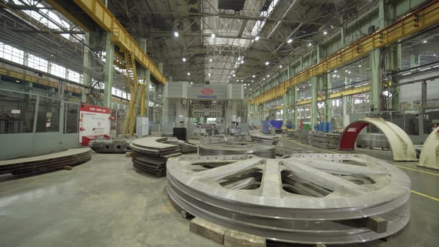 A spacious industrial site showcasing large components and advanced machinery for various manufacturing processes. Stock Clip