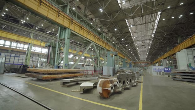 An incredibly expansive view of a modern industrial manufacturing facility showcasing equipment and overhead cranes. Stock Clip