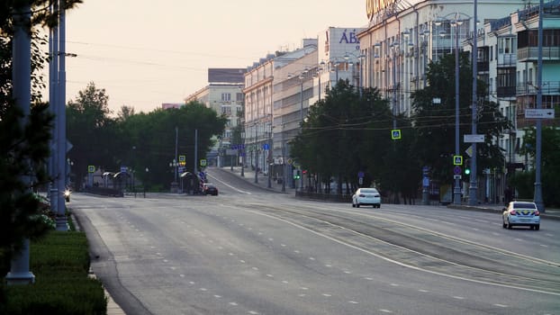 A beautifully serene early morning view of the empty streets lined with green trees and fascinating buildings. Stock Clip