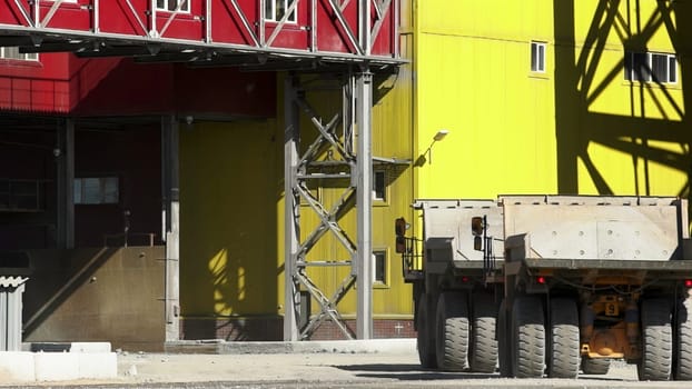 This is a vibrant and bustling industrial site showcasing heavy machinery and colorful structures all around. Stock Clip
