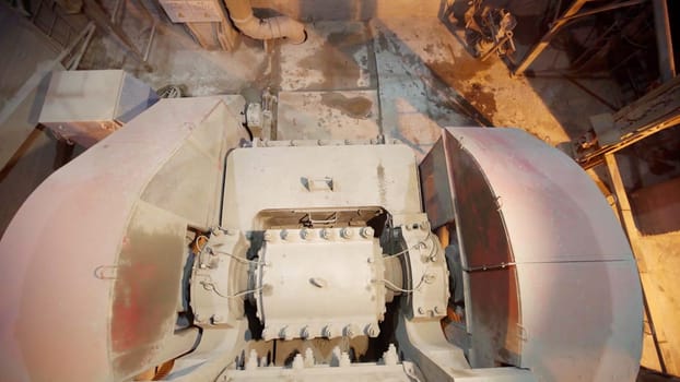 Close-up of industrial machinery showing operational components and dust, highlighting manufacturing processes. Stock Clip