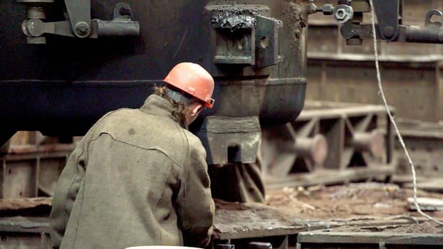 A skilled worker operates complex machinery in a factory, demonstrating dedication and exceptional craftsmanship. Stock Clip