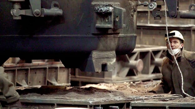 A skilled worker operates complex machinery in a factory, demonstrating dedication and exceptional craftsmanship. Stock Clip