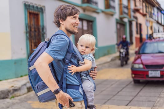 Father and his son tourists walks through the colonial streets San Cristobal de las Casas, Mexico. Cultural exploration, architecture, and travel experience concept.