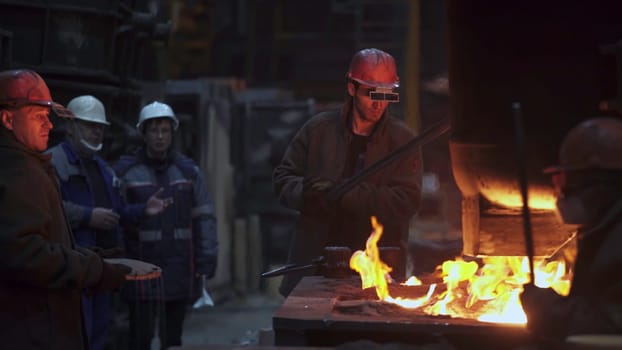 Steel is intensively produced in foundries, where skilled workers handle molten metal and face intense heat. Stock Clip