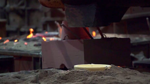 This overview highlights a fascinating metal casting operation with molten metal processed in a foundry. Stock Clip