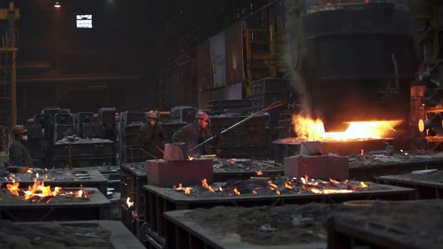 A captivating image showcasing the intricate steel production process taking place within a large industrial foundry. Stock Clip