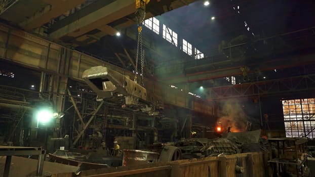 An expansive industrial space exhibiting heavy machinery and cranes actively engaged in their operational tasks. Stock Clip