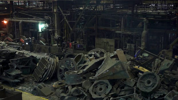 A haunting and eerie view of a derelict factory that is filled with rusted machinery and various debris. Stock Clip