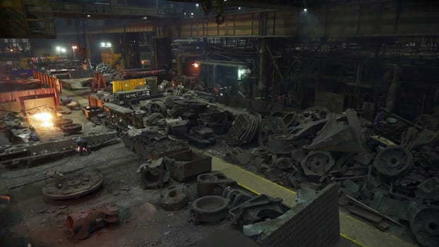 A comprehensive and detailed view of an expansive industrial factory floor filled with various equipment and dust. Stock Clip