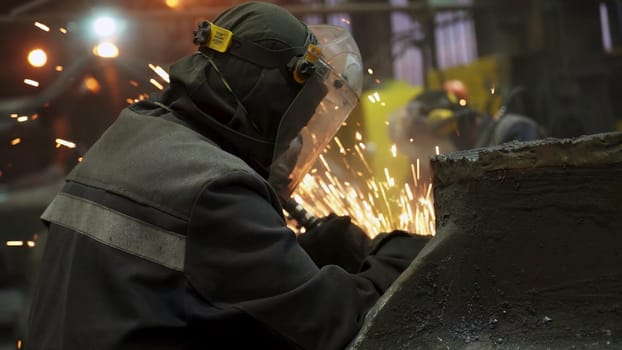 In a lively industrial setting, a highly skilled worker expertly welds pieces of metal, with sparks flying all around. Stock Clip