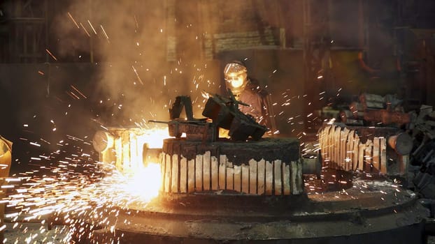A highly intense industrial scene showcases skilled metalworking with vibrant sparks and billowing smoke all around. Stock Clip