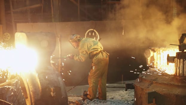 A highly intense industrial scene showcases skilled metalworking with vibrant sparks and billowing smoke all around. Stock Clip
